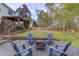 Backyard with adirondack chairs surrounding a fire pit, and a covered patio, ideal for outdoor gatherings at 657 Swans Landing Dr, Dacula, GA 30019