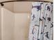 This bathtub is enclosed by a shower curtain decorated with sharks at 657 Swans Landing Dr, Dacula, GA 30019