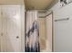 Bathroom showing a shower, shower curtain, and white door at 657 Swans Landing Dr, Dacula, GA 30019