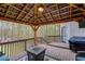 Inviting covered deck featuring a gas fire pit and grill, perfect for outdoor entertaining and relaxation at 657 Swans Landing Dr, Dacula, GA 30019