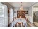 Charming dining room features a chandelier, hardwood floors, and a wooden china cabinet at 657 Swans Landing Dr, Dacula, GA 30019