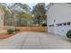 Large driveway with two-car garage, leading to a fenced backyard and ample parking space at 657 Swans Landing Dr, Dacula, GA 30019