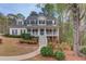 Charming two-story home with a welcoming front porch and beautifully landscaped front yard at 657 Swans Landing Dr, Dacula, GA 30019