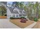 Traditional home with a white exterior, a spacious driveway, and a charming, covered front porch at 657 Swans Landing Dr, Dacula, GA 30019