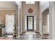 Bright foyer with a high ceiling, laminate floors, and stylish decor sets a welcoming tone at 657 Swans Landing Dr, Dacula, GA 30019