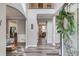 Inviting foyer featuring beautiful laminate floors, high ceilings, and an elegant staircase at 657 Swans Landing Dr, Dacula, GA 30019