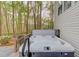 Backyard hot tub provides a relaxing escape surrounded by lush greenery at 657 Swans Landing Dr, Dacula, GA 30019