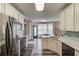 Beautiful kitchen with updated appliances, light wood floors and adjacent breakfast nook and table at 657 Swans Landing Dr, Dacula, GA 30019