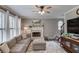 Cozy living room showcasing a fireplace, comfortable seating, and neutral decor for relaxed living at 657 Swans Landing Dr, Dacula, GA 30019