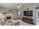 Inviting living room with a fireplace, television and comfortable seating for relaxation and entertainment at 657 Swans Landing Dr, Dacula, GA 30019