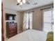 This main bedroom features a four-poster bed and a large flatscreen television at 657 Swans Landing Dr, Dacula, GA 30019