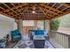 Back patio area with outdoor furniture, a covered roof, and decorative rug at 657 Swans Landing Dr, Dacula, GA 30019