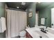 Bathroom featuring a shower/tub combo, dark green walls, and white countertop at 1012 E Paces Chase, Atlanta, GA 30326