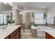 Bright bathroom featuring double sinks, soaking tub, and separate shower with tile at 1012 E Paces Chase, Atlanta, GA 30326