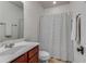 Neat bathroom featuring a classic vanity, toilet, and a shower with a patterned curtain at 1012 E Paces Chase, Atlanta, GA 30326