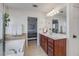 Spacious bathroom featuring soaking tub, vanity, and a view into the main bedroom at 1012 E Paces Chase, Atlanta, GA 30326
