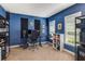Blue bedroom with dark carpet, a desk, a keyboard, and windows with natural light at 1012 E Paces Chase, Atlanta, GA 30326