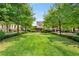 Beautiful community green space with lush lawn, mature trees, and a gazebo in the distance at 1012 E Paces Chase, Atlanta, GA 30326