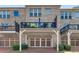 Townhome exterior with brick facade, driveway, carport, and multiple outdoor balconies at 1012 E Paces Chase, Atlanta, GA 30326