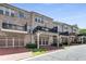 Exterior view of townhomes with brick facade, driveways, carports, and balconies at 1012 E Paces Chase, Atlanta, GA 30326