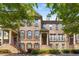 Charming brick townhome featuring a welcoming front porch and well-maintained landscaping, perfect for curb appeal at 1012 E Paces Chase, Atlanta, GA 30326