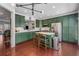 Modern kitchen with an island, stainless steel appliances, custom green cabinets, and hardwood floors at 1012 E Paces Chase, Atlanta, GA 30326
