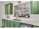 Kitchen featuring stainless steel appliances, custom green cabinetry, white subway tile backsplash, and modern fixtures at 1012 E Paces Chase, Atlanta, GA 30326