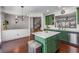 Bright kitchen featuring an island, stainless steel appliances, custom green cabinetry, and hardwood floors at 1012 E Paces Chase, Atlanta, GA 30326