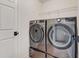 Laundry area with stacked washer and dryer, white door, and wire shelving at 1012 E Paces Chase, Atlanta, GA 30326