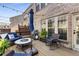 Inviting patio with brick exterior, string lights, ample seating and a grill for outdoor dining at 1012 E Paces Chase, Atlanta, GA 30326