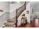 Elegant staircase with wood railing, carpeted steps, and decorative accents at 1012 E Paces Chase, Atlanta, GA 30326
