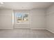 Spacious bedroom featuring a large window offering an abundance of natural light, complemented by neutral walls and carpet at 1054 Georgian Point Dr, Lawrenceville, GA 30045