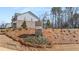 The Alcove Village brick community sign stands in front of a new home under construction at 1054 Georgian Point Dr, Lawrenceville, GA 30045