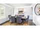 Elegant dining room with gray chairs, decorative rug, crown molding and natural light at 1054 Georgian Point Dr, Lawrenceville, GA 30045