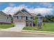 Charming two-story home with a brick and siding exterior, complemented by a well-manicured lawn and a two-car garage at 1054 Georgian Point Dr, Lawrenceville, GA 30045