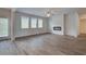 Large living room with fireplace, bright windows, and wood-style laminate flooring at 1054 Georgian Point Dr, Lawrenceville, GA 30045