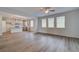 Spacious living room with bright windows and vinyl flooring, flowing into the modern kitchen at 1054 Georgian Point Dr, Lawrenceville, GA 30045