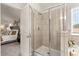 Bathroom showcasing walk-in tiled shower with glass door and tile surround, plus a view to a main bedroom at 1054 Georgian Point Dr, Lawrenceville, GA 30045
