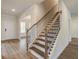 Modern staircase with wood steps, black metal railings, and natural light at 1054 Georgian Point Dr, Lawrenceville, GA 30045