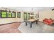 Finished basement area with billiards table, warm lighting, and ample space for recreation and relaxation at 221 Streamside Ct, Lilburn, GA 30047