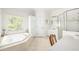 Serene bathroom with a soaking tub, separate shower, and a double vanity at 221 Streamside Ct, Lilburn, GA 30047