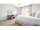 Well-lit bedroom featuring a ceiling fan, natural light, and a connecting ensuite bathroom at 221 Streamside Ct, Lilburn, GA 30047