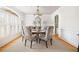 Formal dining room featuring hardwood floors, decorative chairs, and ample natural light at 221 Streamside Ct, Lilburn, GA 30047