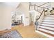 Grand foyer with hardwood floors, a staircase, and views into the dining and living areas at 221 Streamside Ct, Lilburn, GA 30047