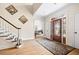 Bright foyer with hardwood floors, a decorative door, and staircase leading to the upper level at 221 Streamside Ct, Lilburn, GA 30047