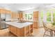 Bright kitchen with an island, stainless steel appliances, natural wood cabinetry, and a breakfast nook at 221 Streamside Ct, Lilburn, GA 30047
