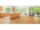 Bright kitchen with hardwood floors, center island, and an attached dining area with scenic views at 221 Streamside Ct, Lilburn, GA 30047