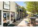Charming street view of businesses with outdoor seating and trees in the historic downtown district at 221 Streamside Ct, Lilburn, GA 30047