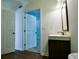 Stylish bathroom with wood-look flooring, new vanity, and a mirror and view to bedroom at 3088 Mount Tabor Church Rd, Dallas, GA 30157