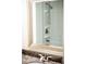 Close-up view in mirror of shower/tub combo and vanity in bright, white-themed bathroom at 3088 Mount Tabor Church Rd, Dallas, GA 30157